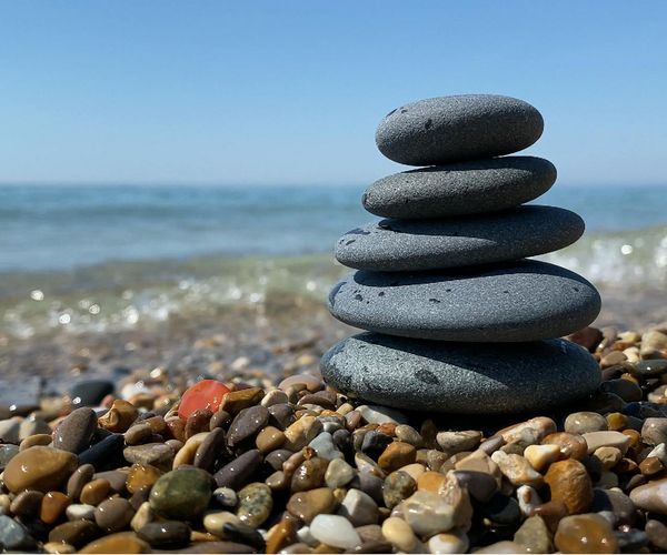 A serene scene with stacked stones, symbolizing balance and wellness.